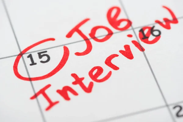 Close up view of print calendar with red mark and job interview words — Stock Photo