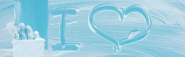 Panoramic shot of cleaner with sponge near i love lettering on glass with white foam on blue background — Stock Photo