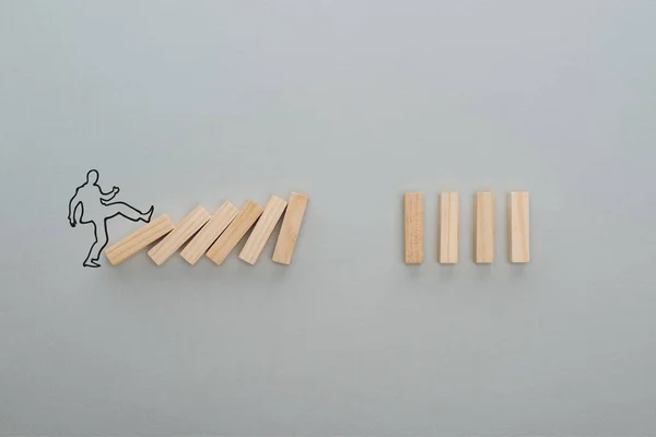 Vue du dessus de l'homme dessiné poussant des blocs de bois sur fond gris, concept d'entreprise — Photo de stock