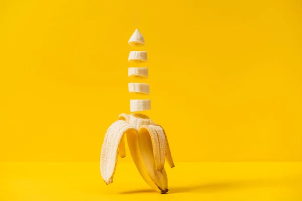 Sliced tropic sweet delicious banana isolated on yellow — Stock Photo