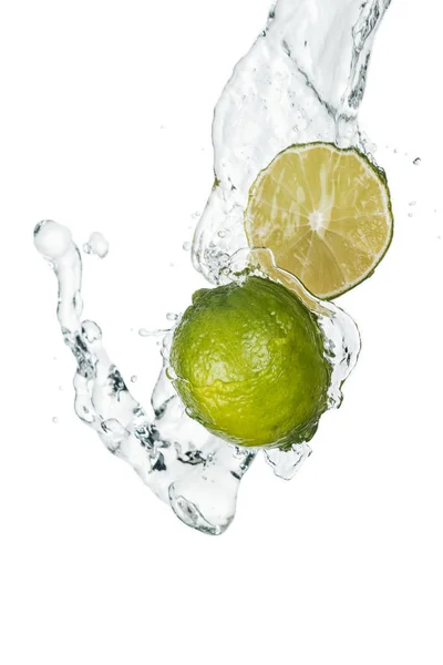 Green fresh whole lime and half with clear water stream and drops isolated on white — Stock Photo