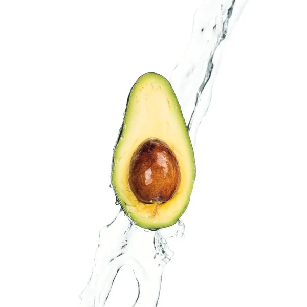 Ripe nutritious avocado half with seed and transparent water stream isolated on white — Stock Photo