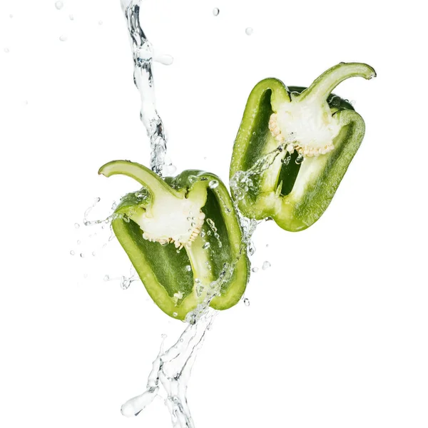 Green bell pepper halves and clear water splash with drops isolated on white — Stock Photo