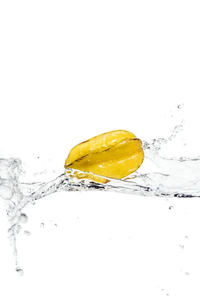 Whole ripe exotic star fruit and water splash isolated on white — Stock Photo