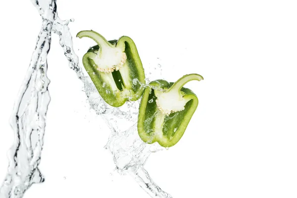 Ripe green bell pepper halves and clear water streams with drops isolated on white — Stock Photo