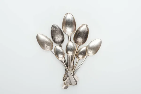 Top view of shiny vintage silver empty spoons on white background — Stock Photo