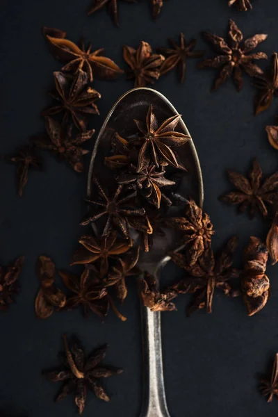 Top view of anise in silver spoon on black background — Stock Photo