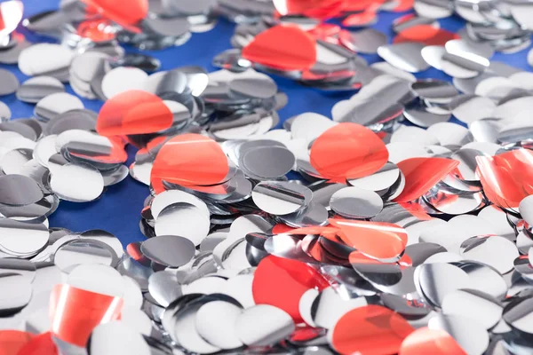 Selective focus of silver and red confetti background — Stock Photo