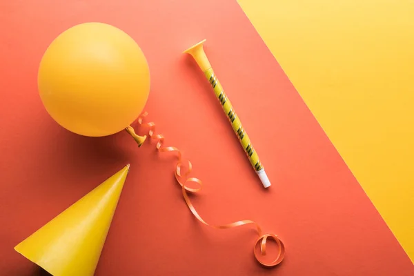 Top view of party decoration on coral yellow background — Stock Photo