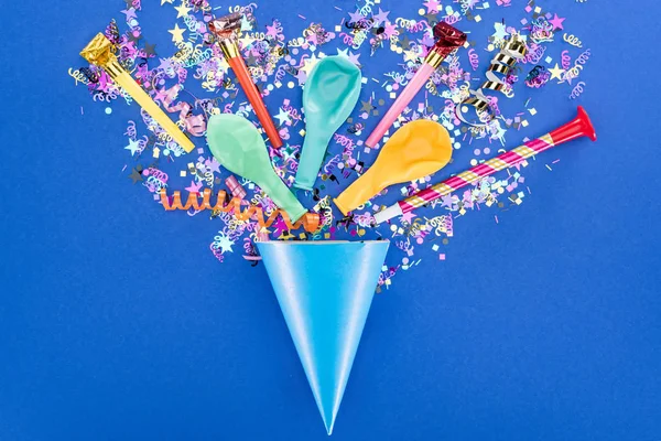 Blue party hat with festive decoration on blue background — Stock Photo