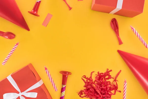 Red birthday party objects on yellow background — Stock Photo