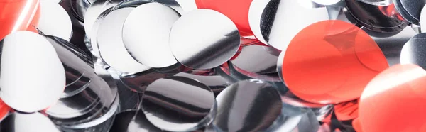 Панорамный снимок блестящего серебра и красных конфетти — стоковое фото