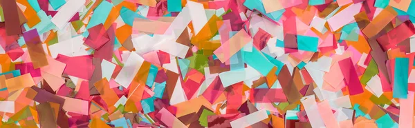 Panoramic shot of multicolored confetti festive background — Stock Photo