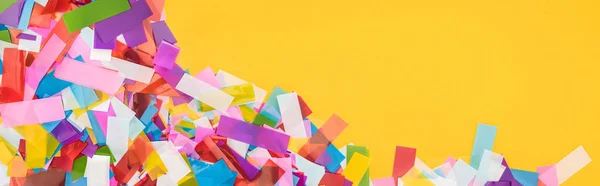 Panoramic shot of colorful confetti frame on yellow background — Stock Photo