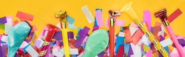 Panoramic shot of party decoration on yellow festive background — Stock Photo