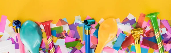 Panoramic shot of birthday decoration on yellow party background — Stock Photo