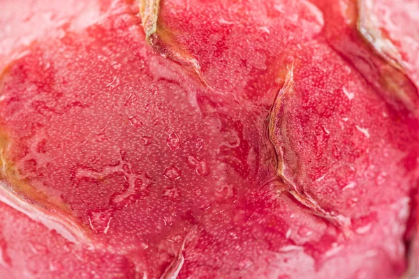 Close up view of wet exotic ripe dragon fruit pink textured peel — Stock Photo