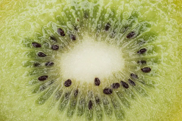 Close up view of cut fresh nutritious green kiwi with black seeds — Stock Photo