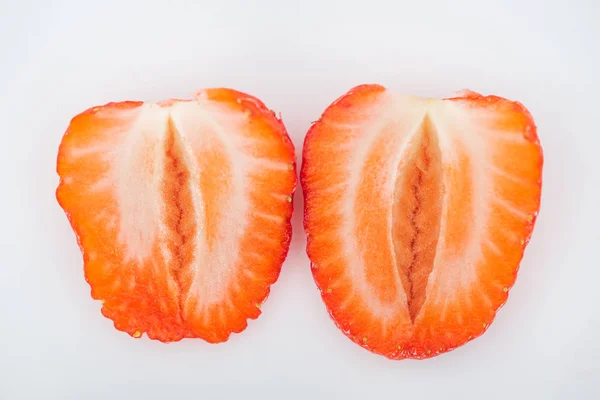 Vue rapprochée des moitiés fraîches de fraises rouges mûres sur fond blanc — Photo de stock