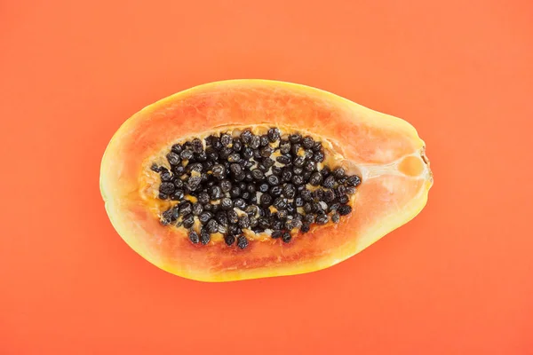 Top view of ripe exotic papaya half isolated on orange — Stock Photo