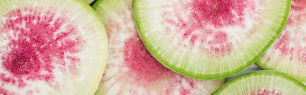 Panoramic shot of cut raw fresh watermelon radish purple slices — Stock Photo