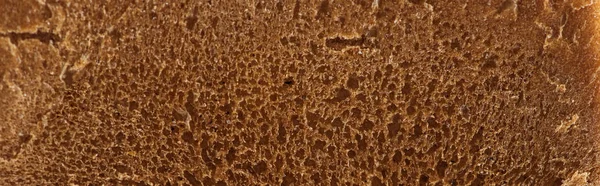 Panoramic shot of brown fresh textured bread — Stock Photo