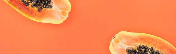 Panoramic shot of ripe papaya halves isolated on orange — Stock Photo