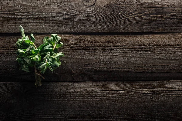 Top view of green fresh mint on wooden rustic table — Stock Photo