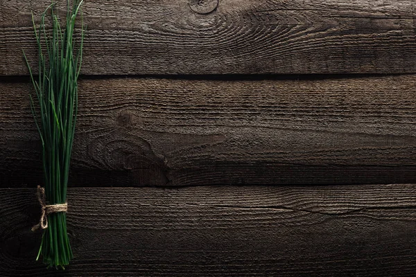 Top view of green onion on wooden weathered table with copy space — Stock Photo