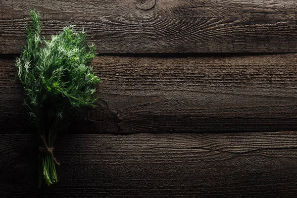 Top view of green dill on wooden weathered table with copy space — Stock Photo