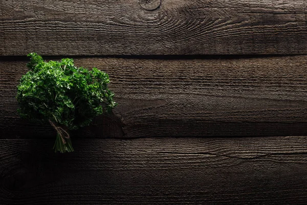 Top view of green parsley on wooden weathered table with copy space — Stock Photo