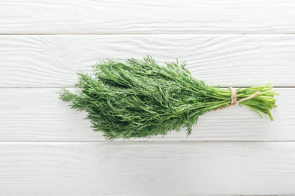Top view of fresh green dill on white wooden table — Stock Photo