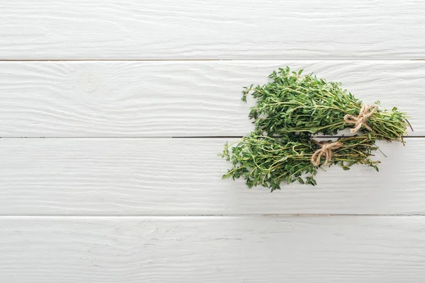 Draufsicht auf frischen grünen Thymian auf weißem Holztisch — Stockfoto