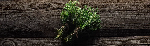 Top view of green fresh thyme on wooden brown rustic table, panoramic shot — Stock Photo