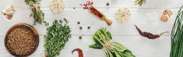 Panoramic shot of green herbs and spices on white wooden table — Stock Photo