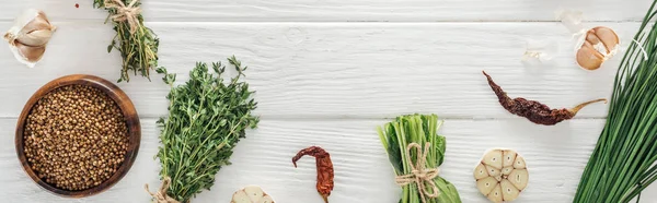 Panoramic shot of green herbs and spices on white wooden table with copy space — Stock Photo