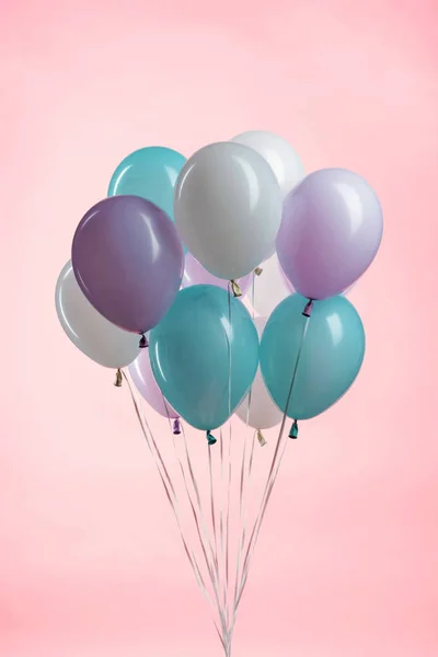 White, blue and purple party festive balloons on pink background — Stock Photo