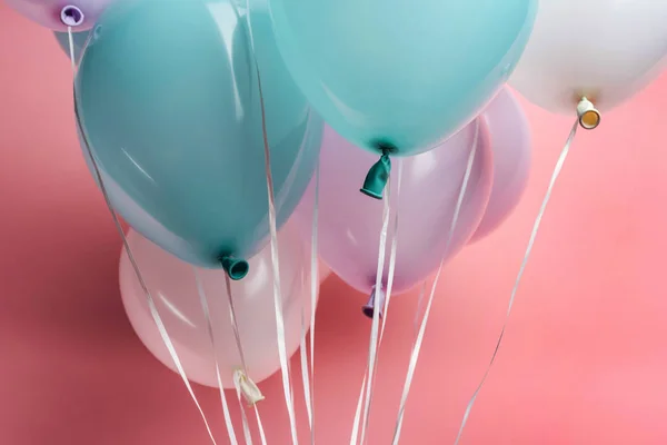 Nahaufnahme weißer, blauer und lila Luftballons auf rosa Hintergrund — Stockfoto