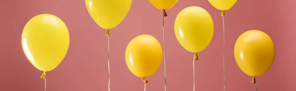 Yellow bright balloons on pink background, party decoration, panoramic shot — Stock Photo