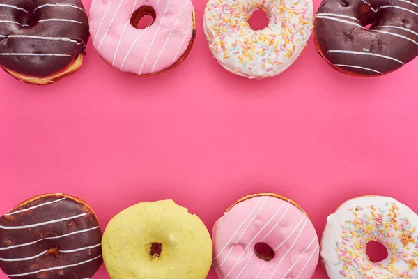 Top view of tasty glazed doughnuts on pink background with copy space — Stock Photo