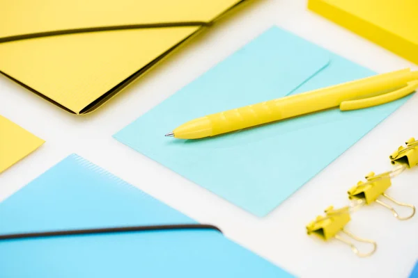 Blue and yellow stationery on white background — Stock Photo