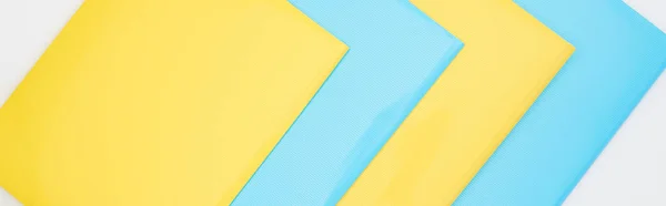 Flat lay of blue and yellow folders isolated on white — Stock Photo