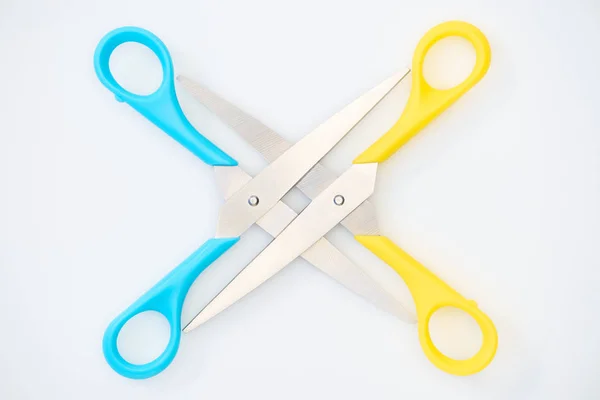 Top view of yellow and blue scissors isolated on white — Stock Photo