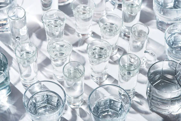 Close up view of transparent glasses with water on white background — Stock Photo