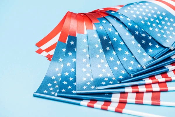 Close up view of satin american flags on blue background — Stock Photo