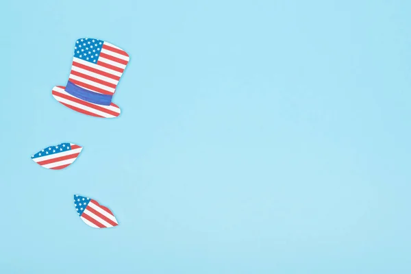 Top view of paper cut mustache and lips made of usa flags on blue background with copy space — Stock Photo