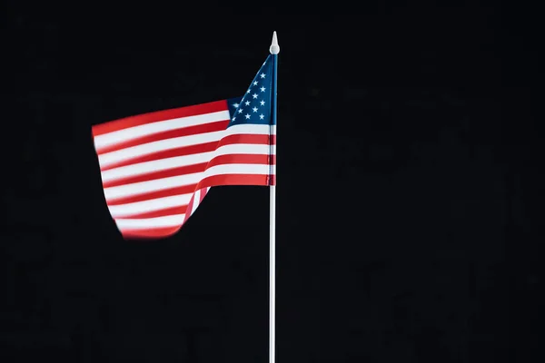 National american flag on stick isolated on black with copy space — Stock Photo