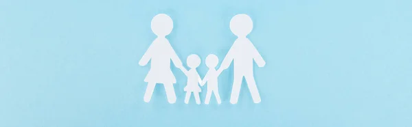Top view of white paper cut family on blue background, panoramic shot — Stock Photo
