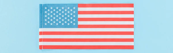 Panoramic shot of national american flag on blue background — Stock Photo