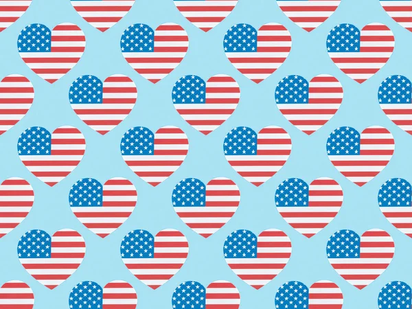 Seamless background pattern with hearts made of american flags on blue — Stock Photo